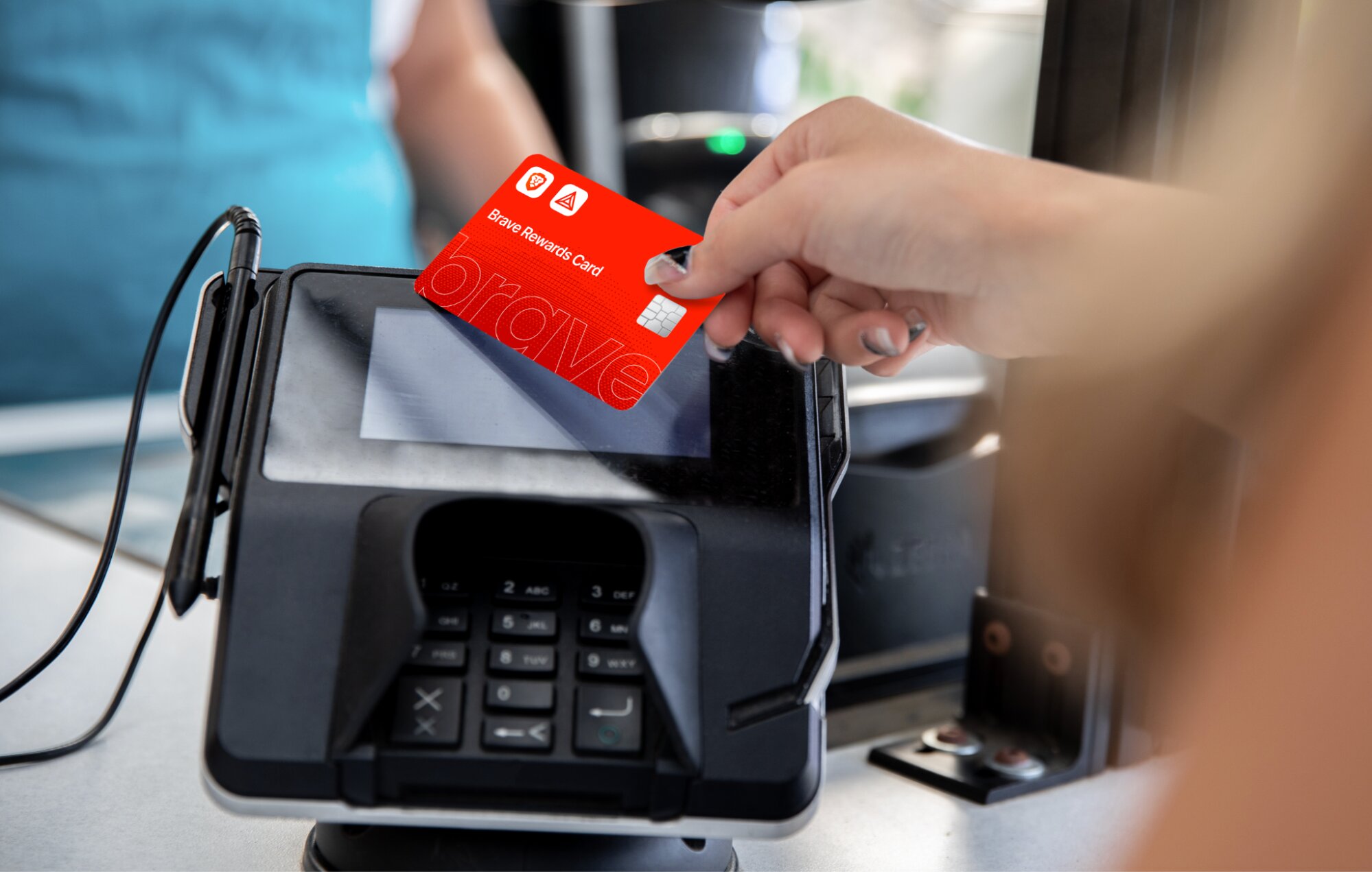 A hand tapping a Brave Rewards Card on a payment terminal to make a contactless in-store purchase.